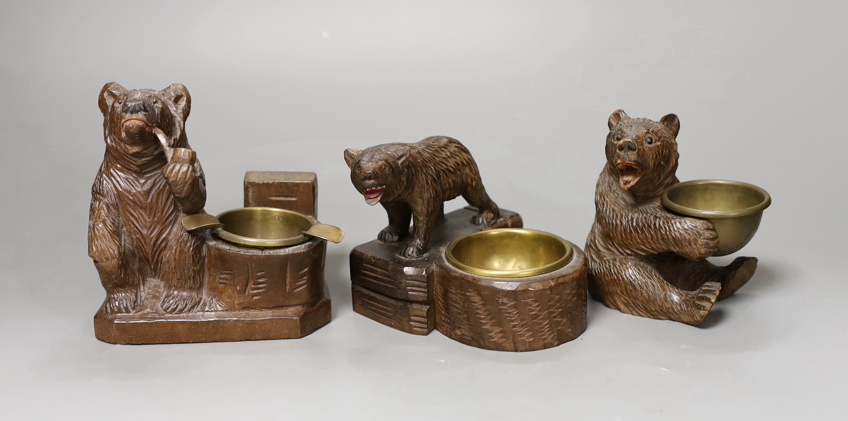 Three Black Forest ‘bear’ match-holders, tallest 11cm